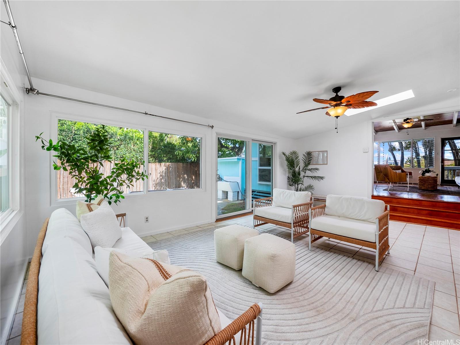 Bright sunroom living space with sliding doors to the yard
