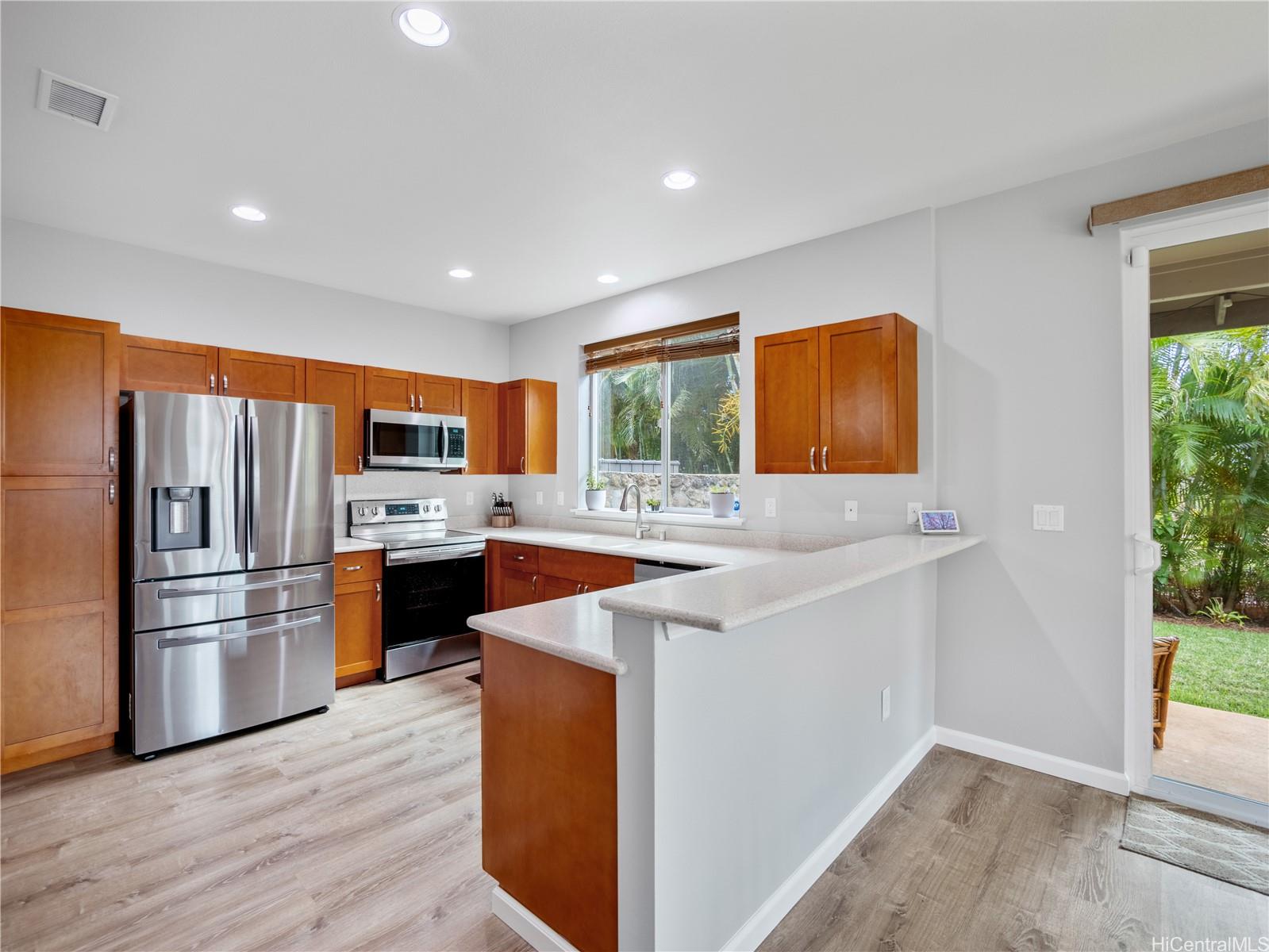 Renovated kitchen with stainless appliances and breakfast bar