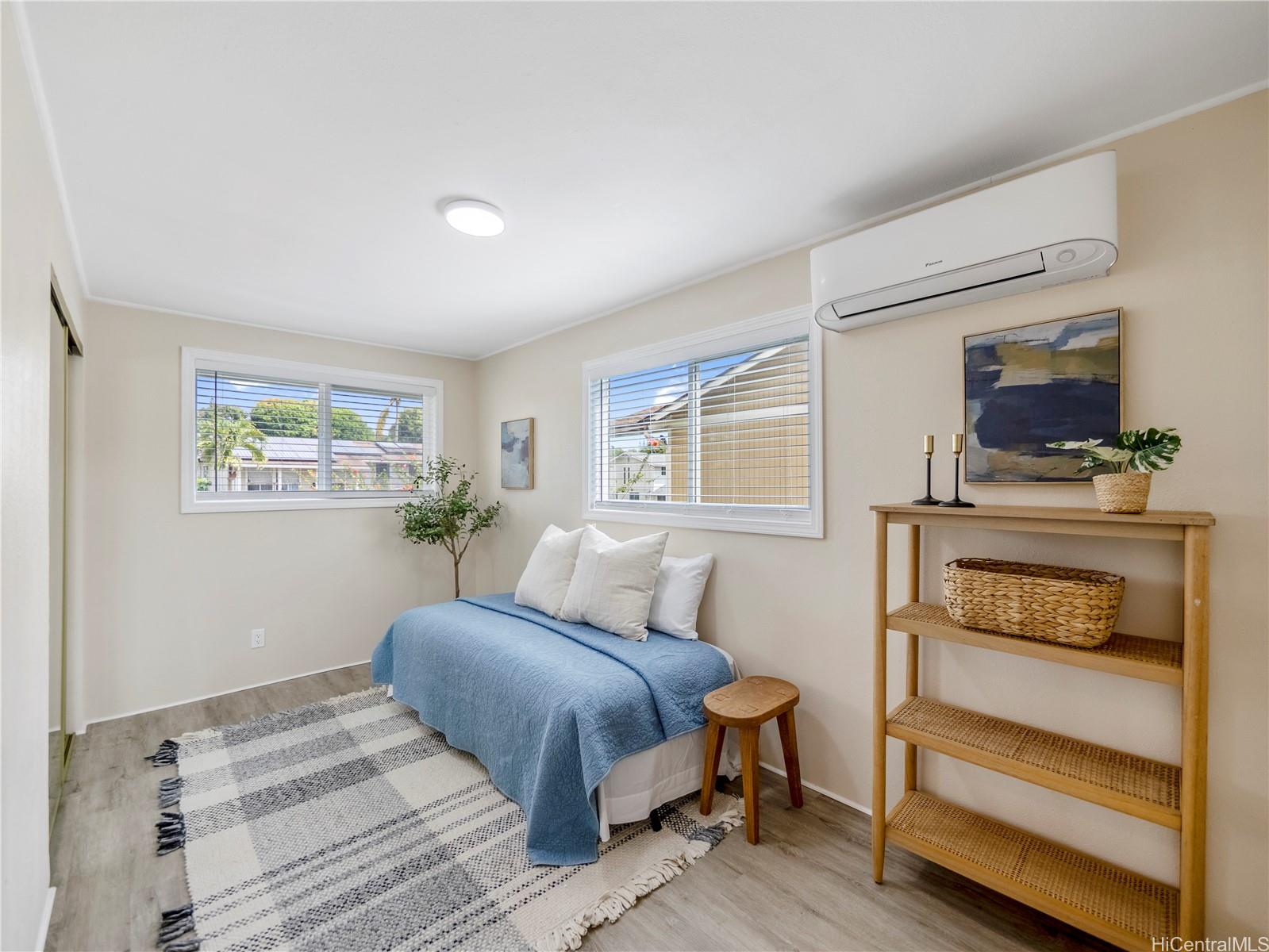 Guest bedroom with split AC and large windows