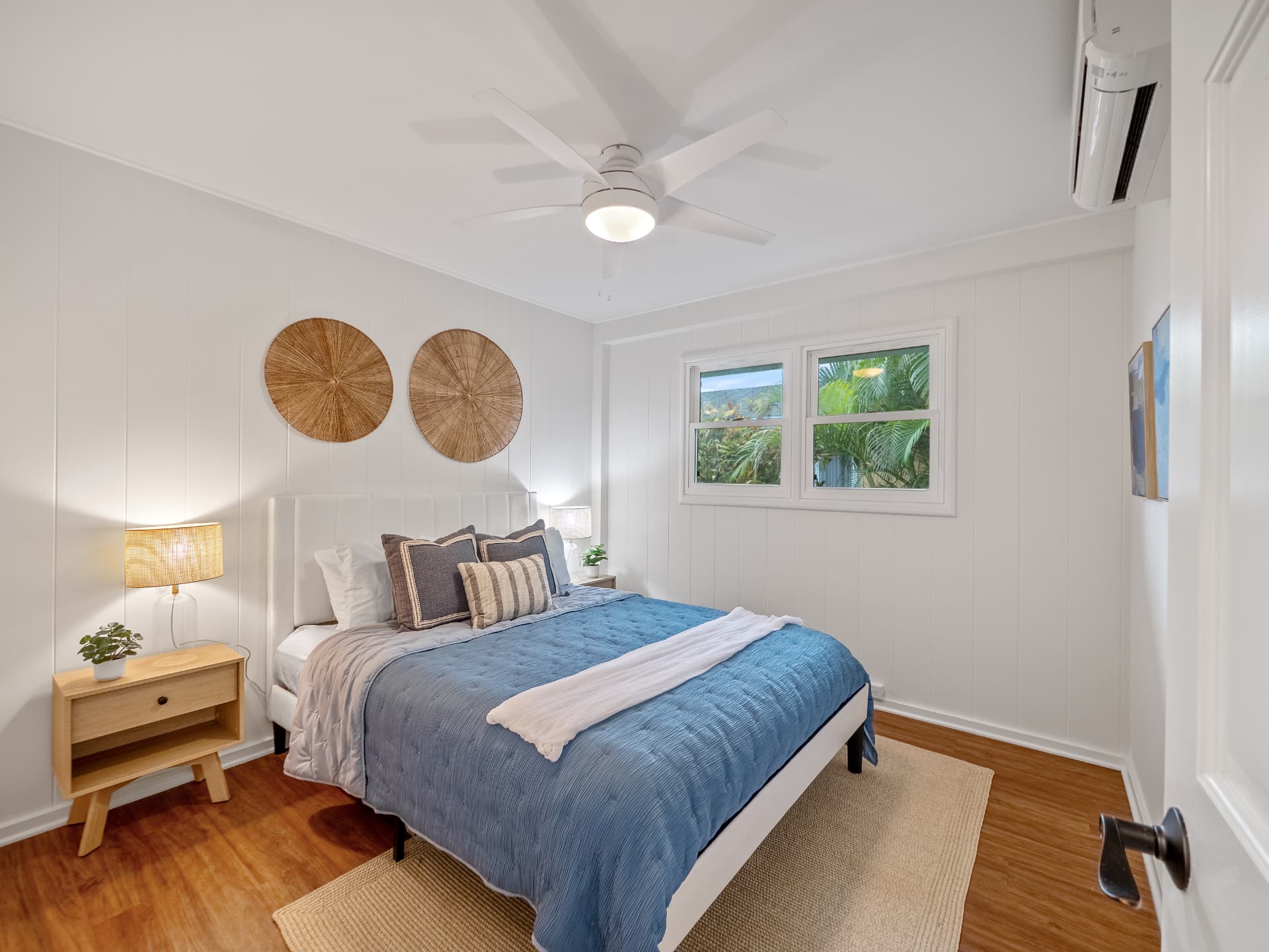 Bedroom with woven wall decor and split AC