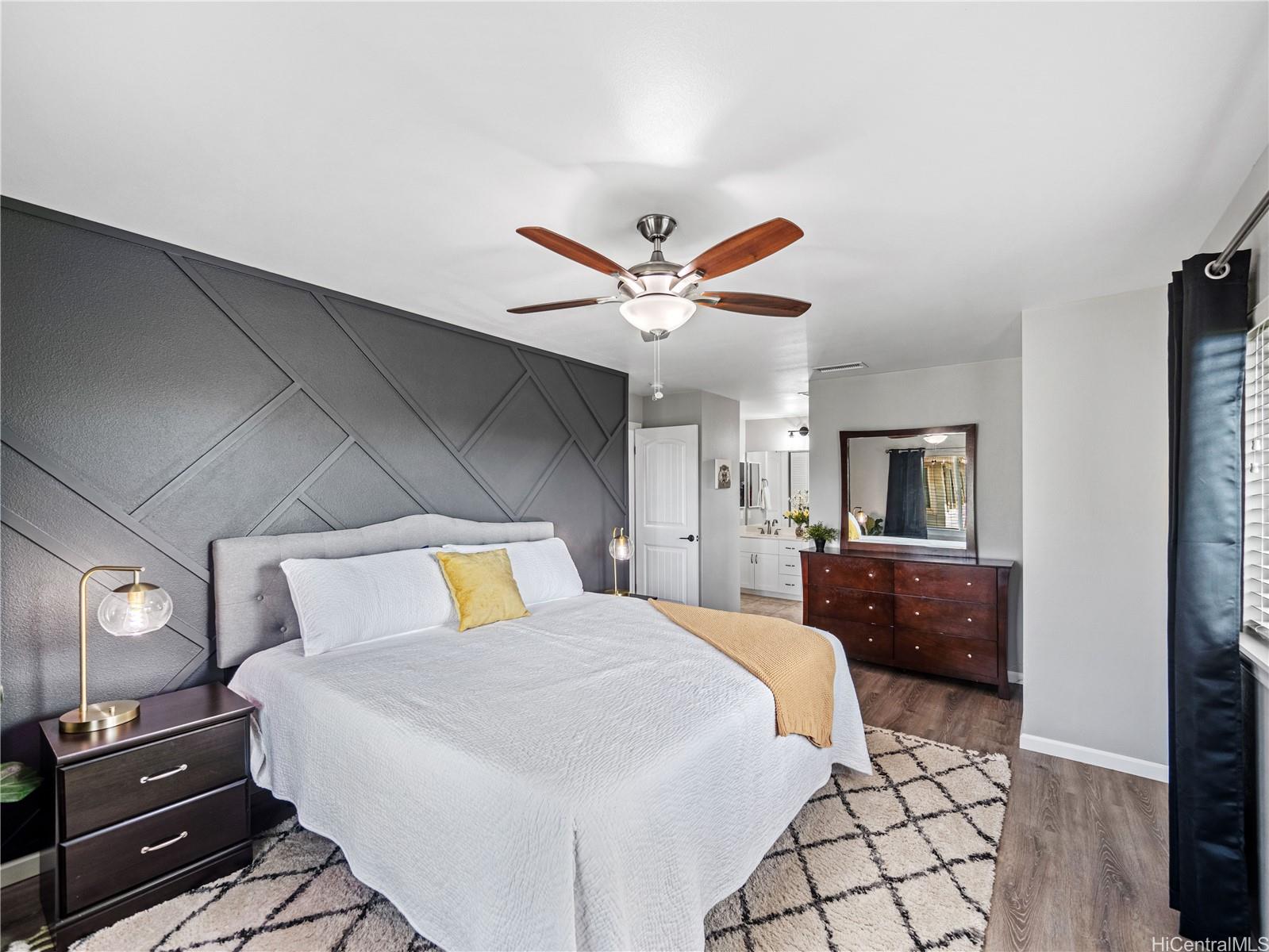 Primary bedroom with accent wall and ensuite