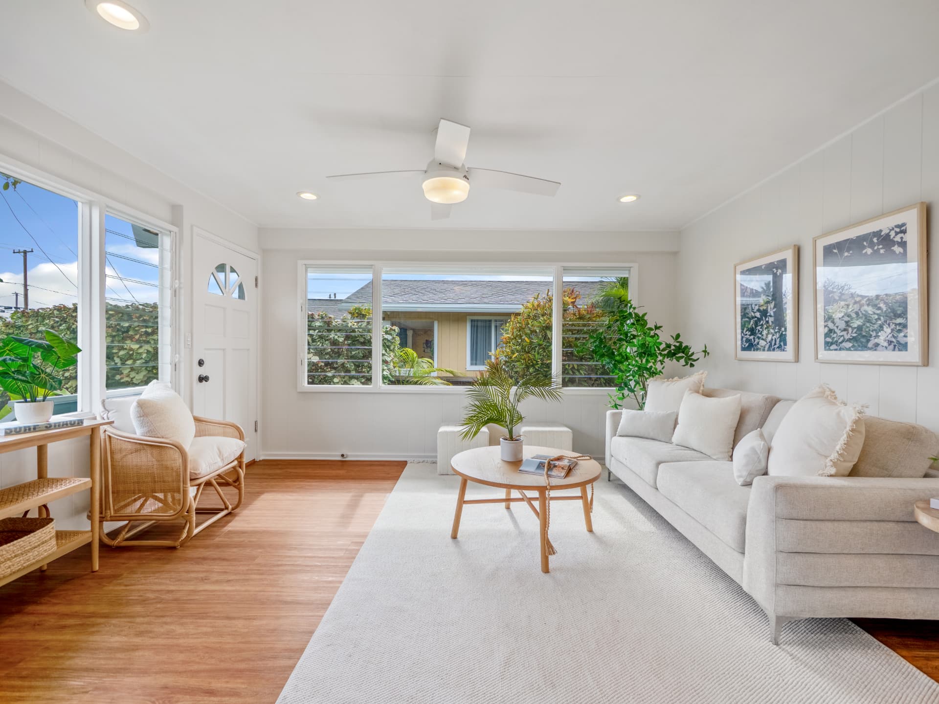 Bright living room with rattan seating and garden views