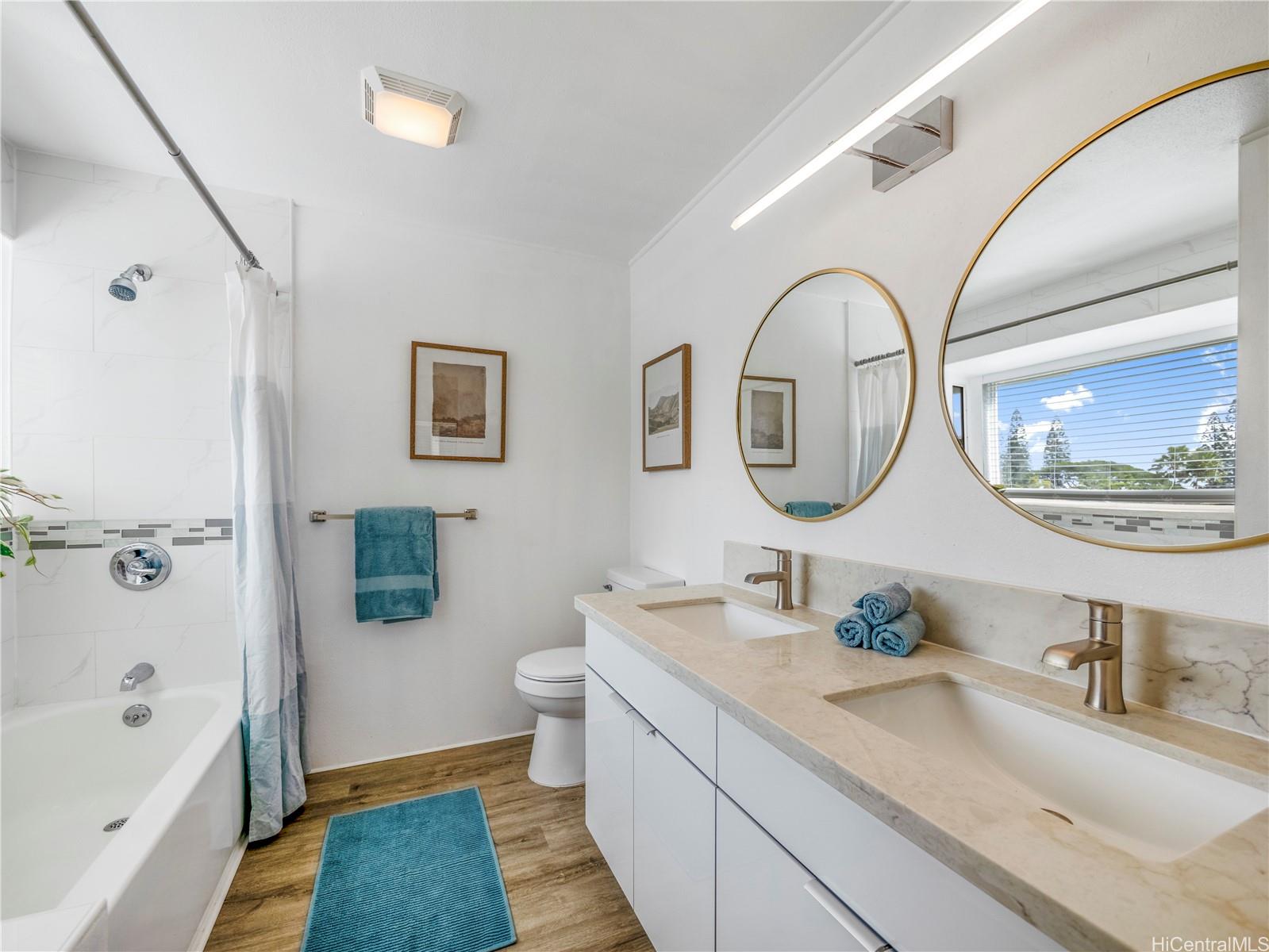 Primary bathroom with dual vanity and tub