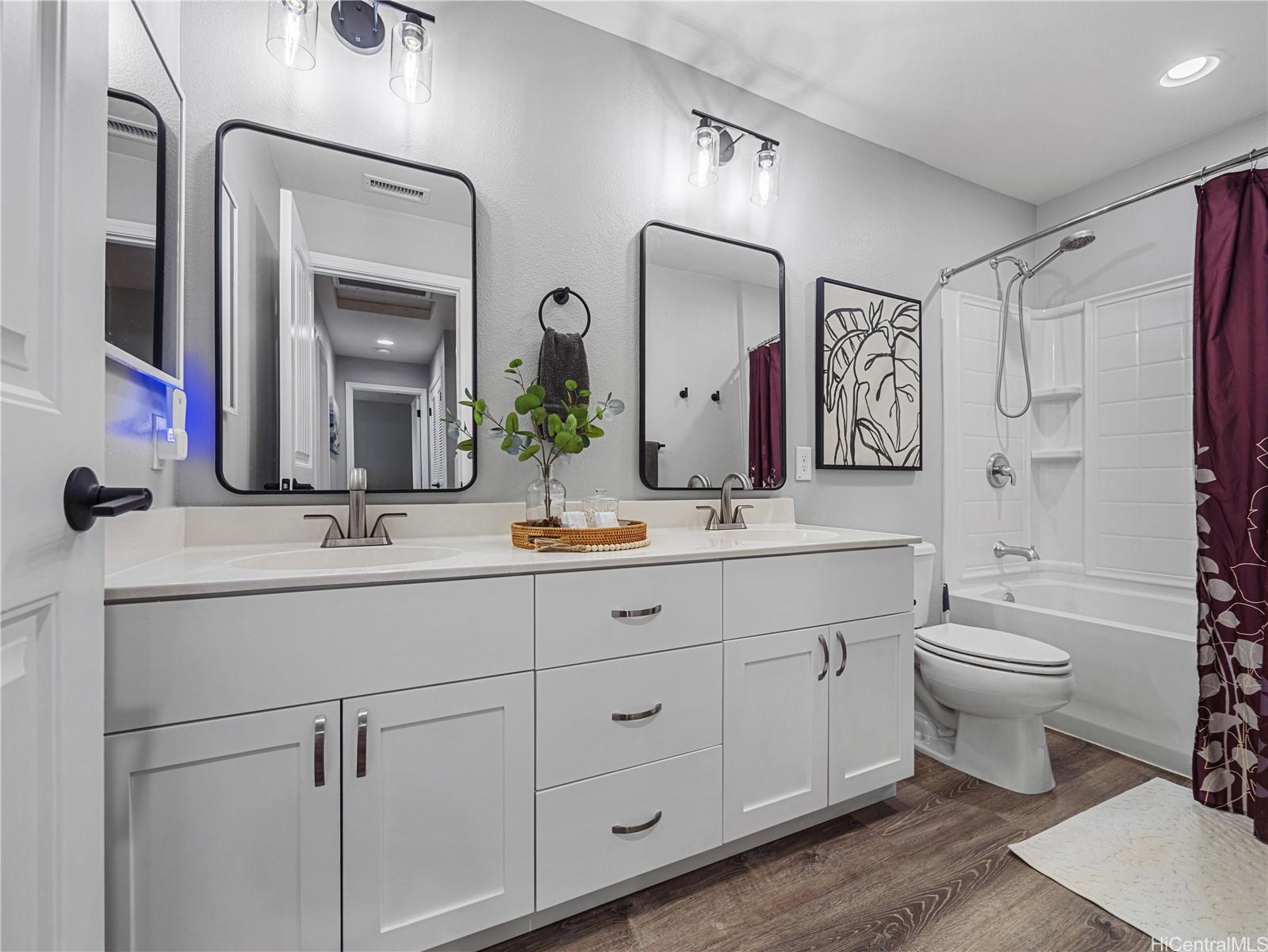 Primary bathroom with dual vanity and tub